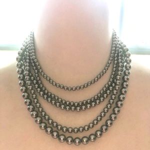 Light blue multi strands pearl necklace.